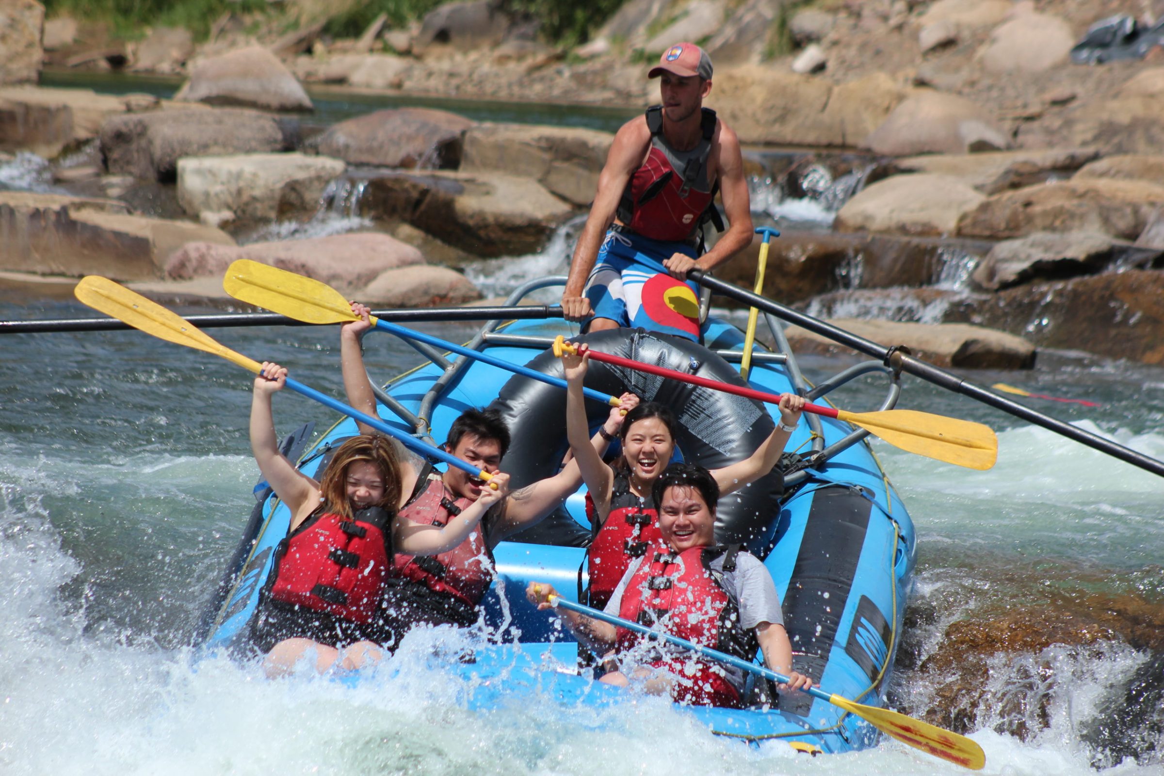 Colorado white water rafting A group of rafters hold their paddles above their heads while white water rafting the lower Animas River