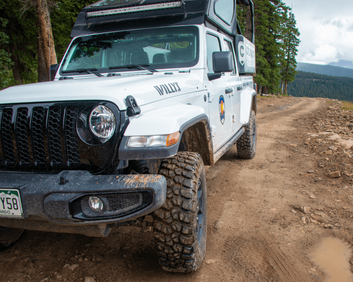 Jeep parked on a dirt trail in the mountains