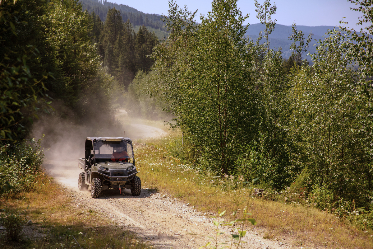 a truck driving down a dirt road