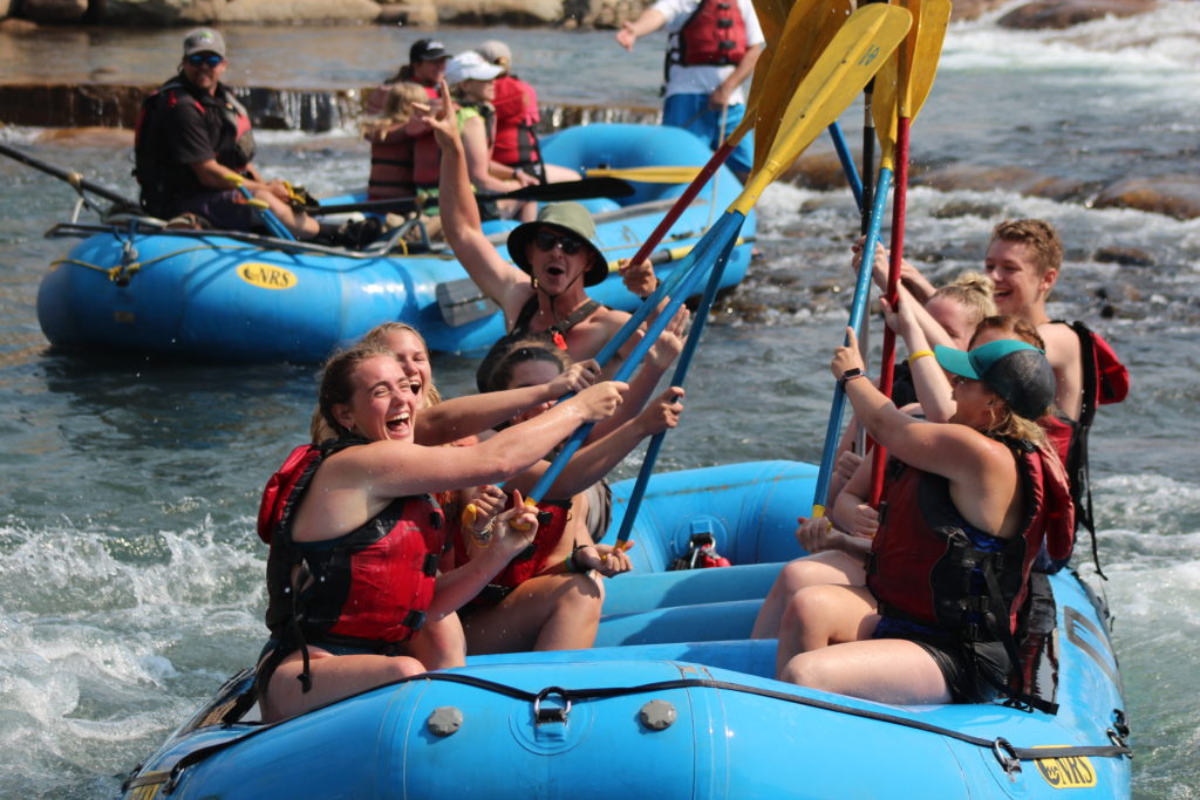 a group of people riding on the back of a boat